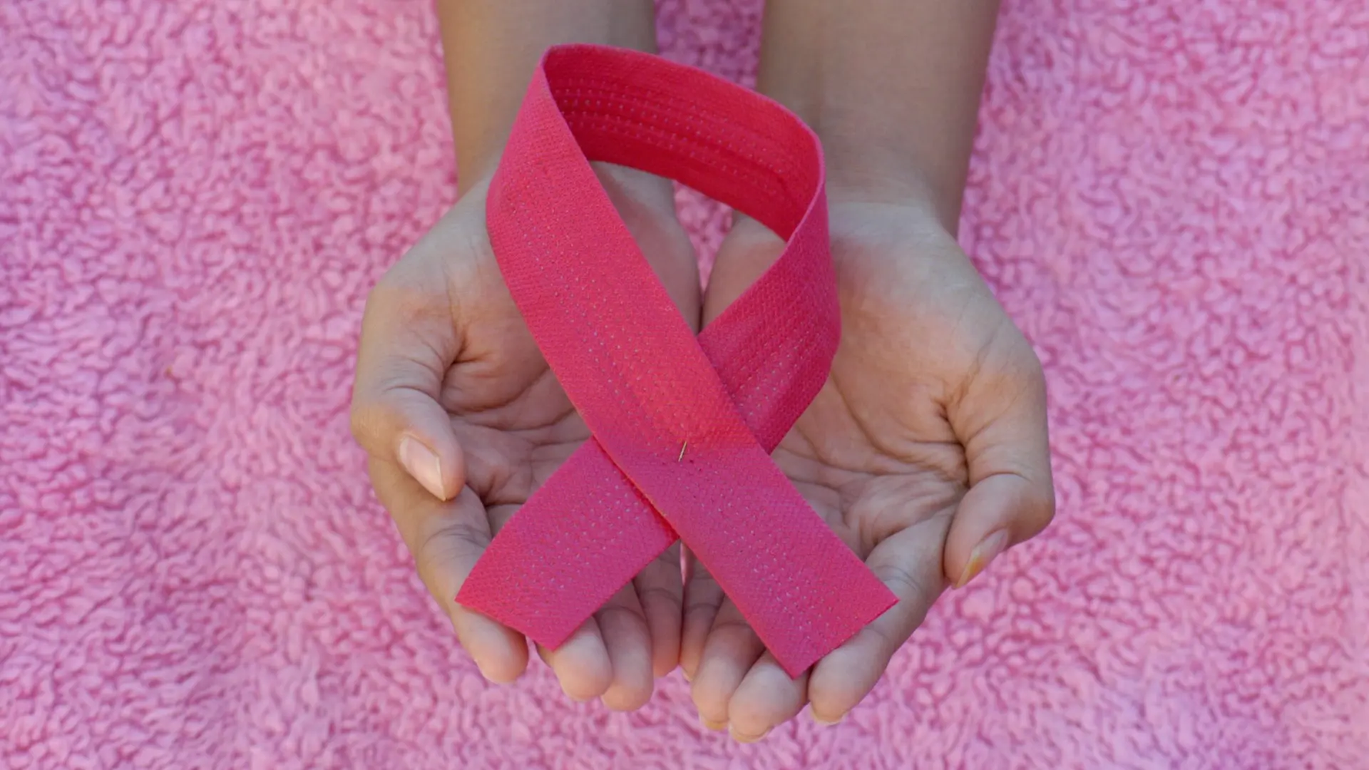 person with pink band on her left hand